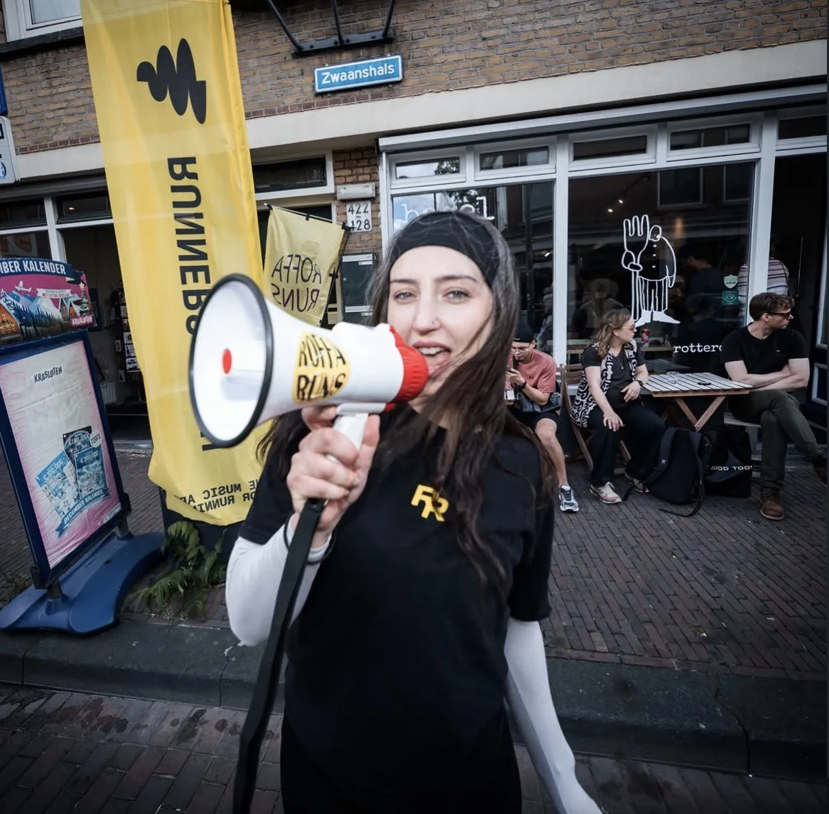 roffa runs organiser with a megaphone outside bagel bagel, zwaanshals 430